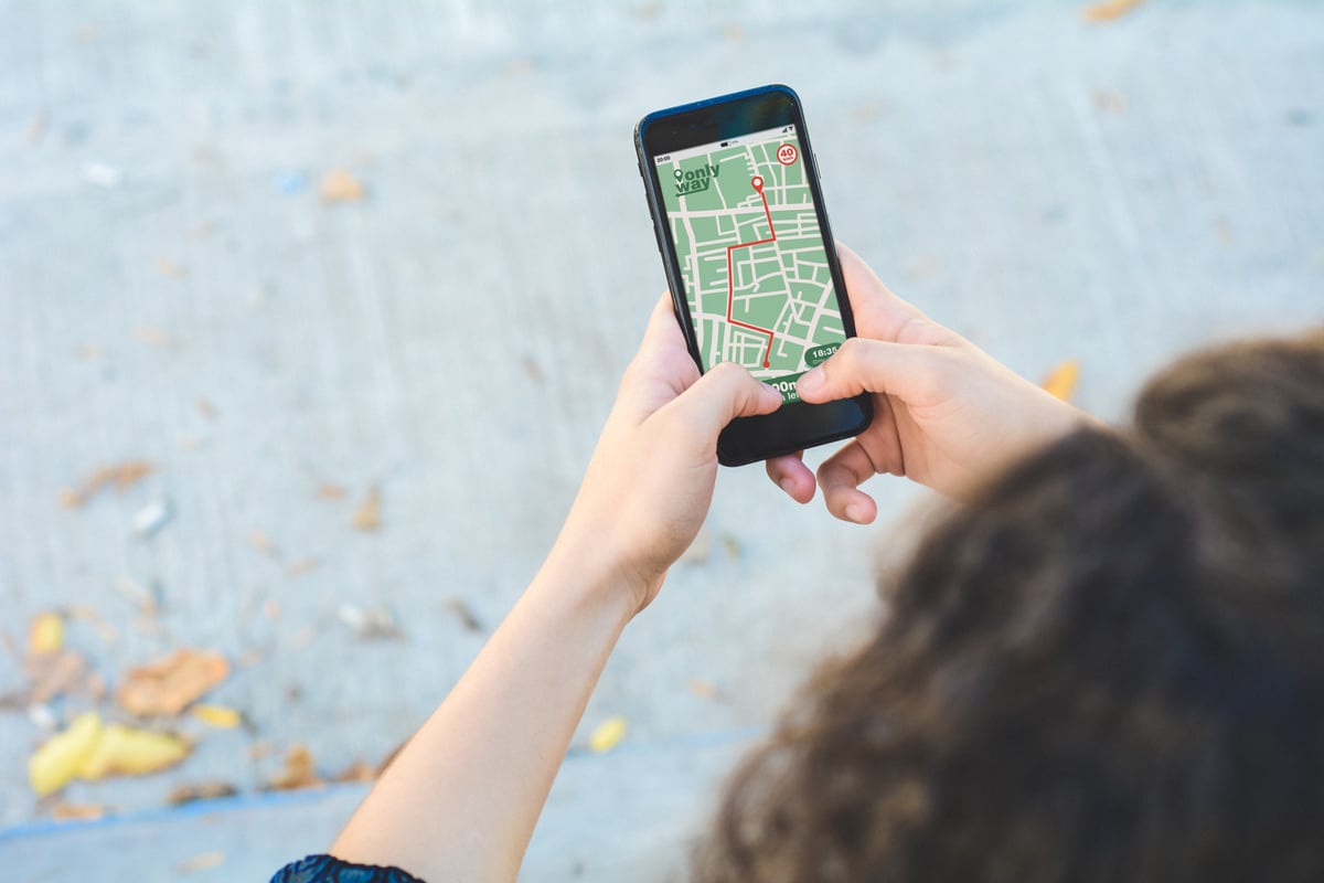 Woman Using Smartphone Navigation App