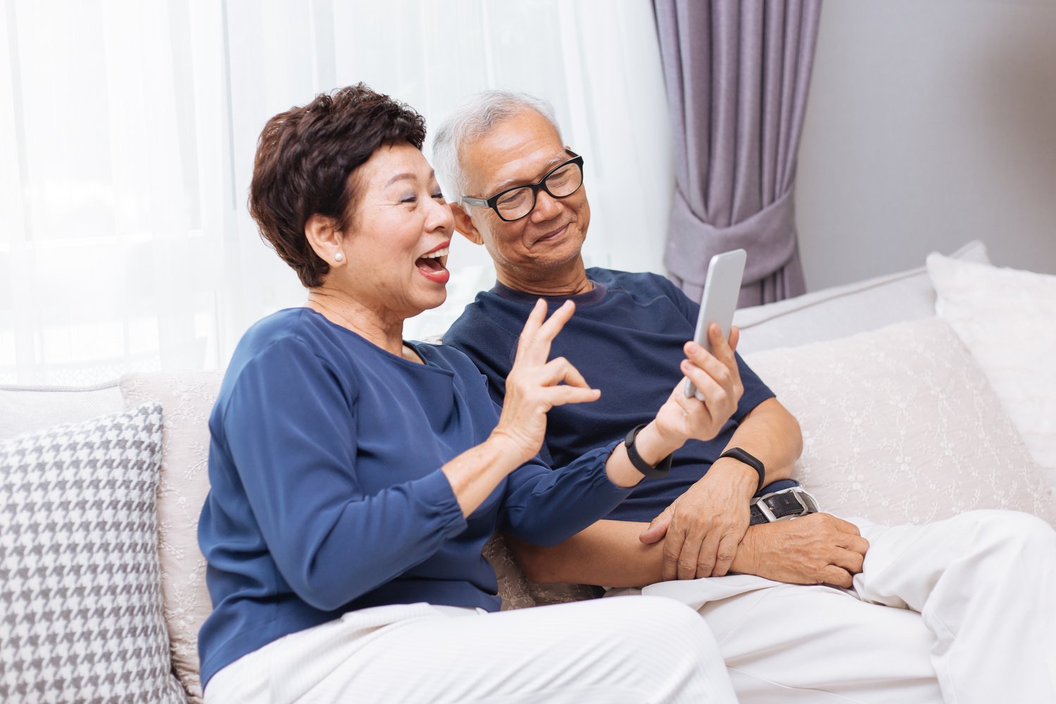 Senior Asian Couple Grandparents Making a Video Call and Waving